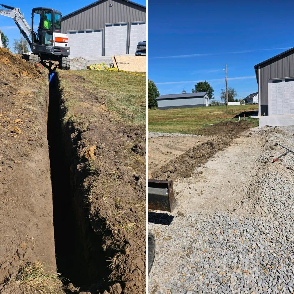 A tractor is digging a hole in the ground next to a garage.