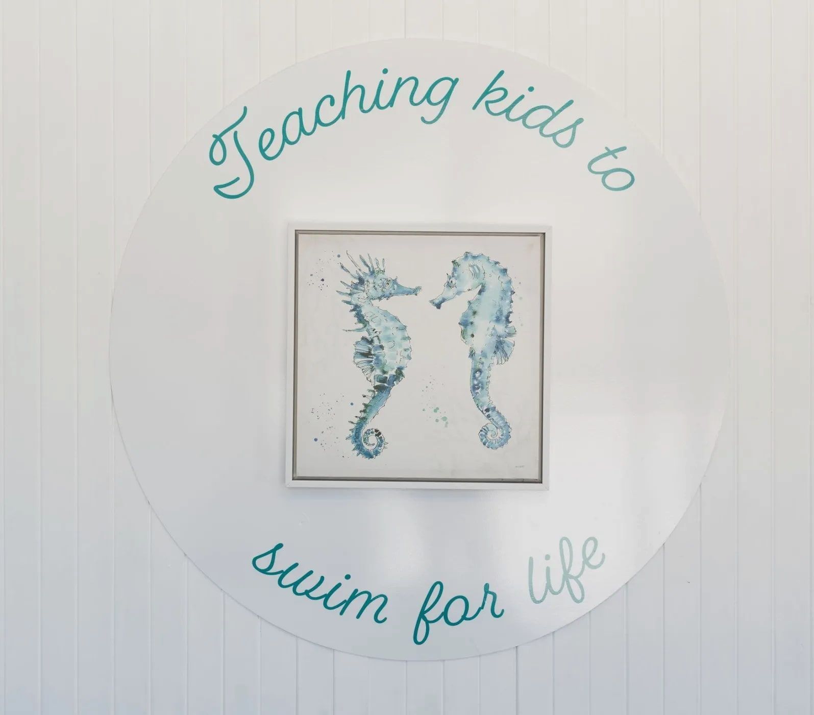 Turquoise Text Around a Framed Seahorse Artwork on a White Wall — North Wyong Aqua Centre in Wyong, NSW