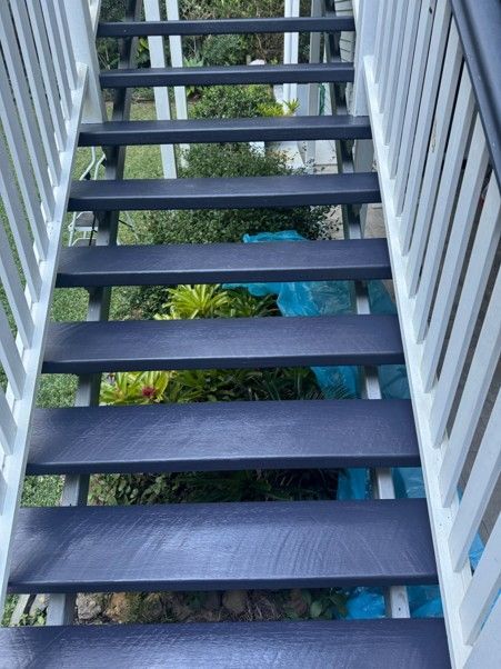 Looking down a black wooden staircase with white railings - Aaron Trigg Painting Sunshine Coast