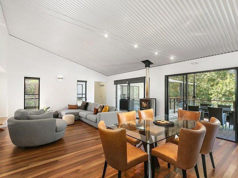 A living room with a dining table and chairs and a couch — Painter In Sunshine Coast, QLD