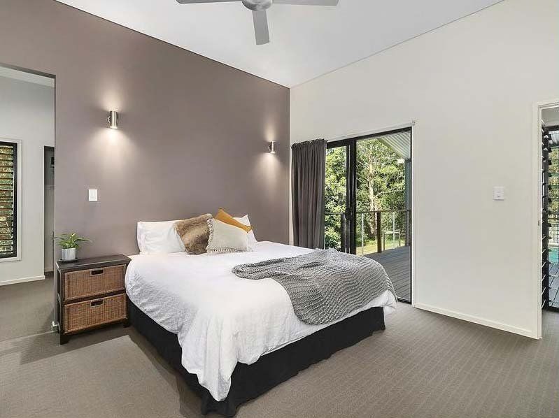 A bedroom with a large bed and a ceiling fan — Painter In Sunshine Coast, QLD