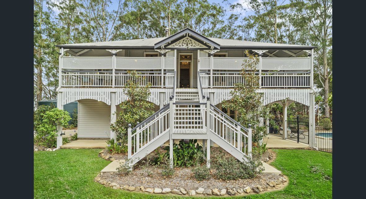 A large white house with a staircase leading up to it — Painter In Sunshine Coast, QLD