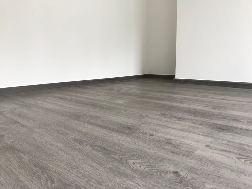 An Empty Room with A Wooden Floor and White Walls — More on the Floor in Barrack Heights, NSW