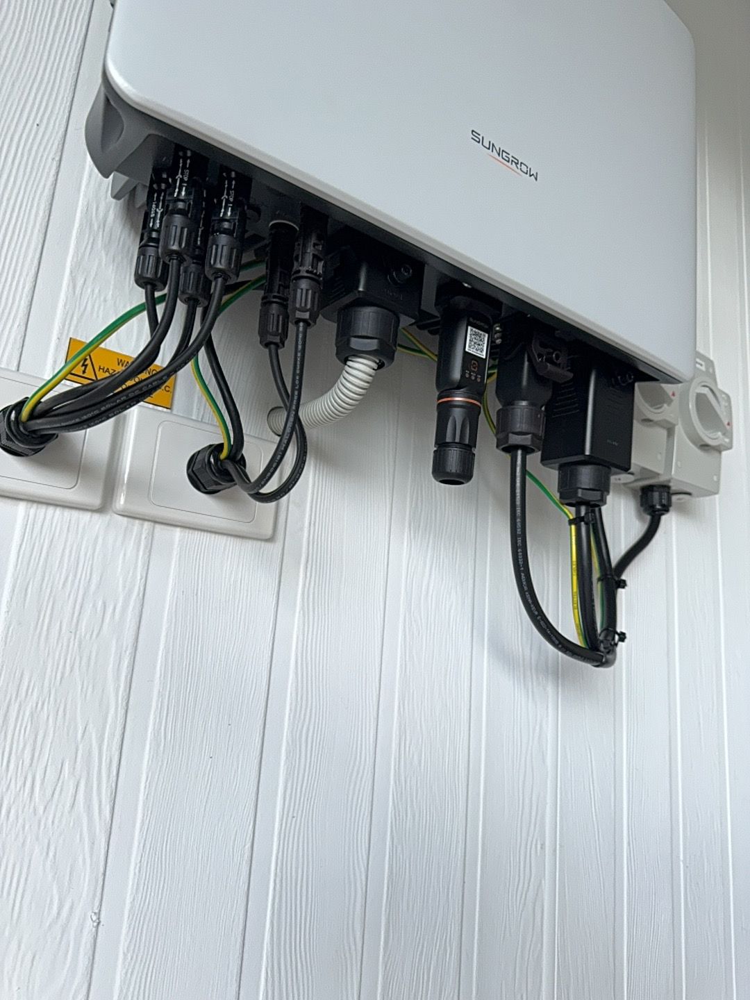 A Solar Panel Sitting On Top Of A White Wooden Wall — Rid-Arc Electrical In Tamworth, NSW
