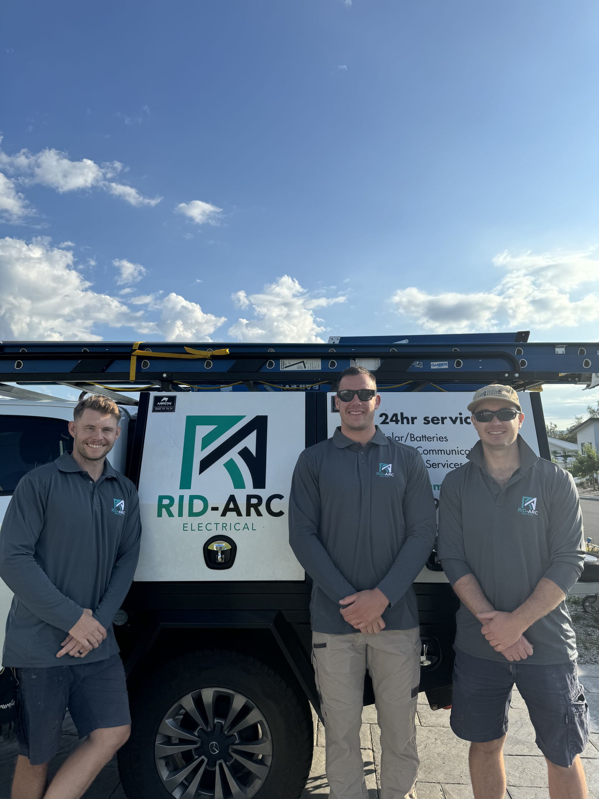 Three Men Posing In Front Of A Work Vehicle— Rid-Arc Electrical In Tamworth, NSW