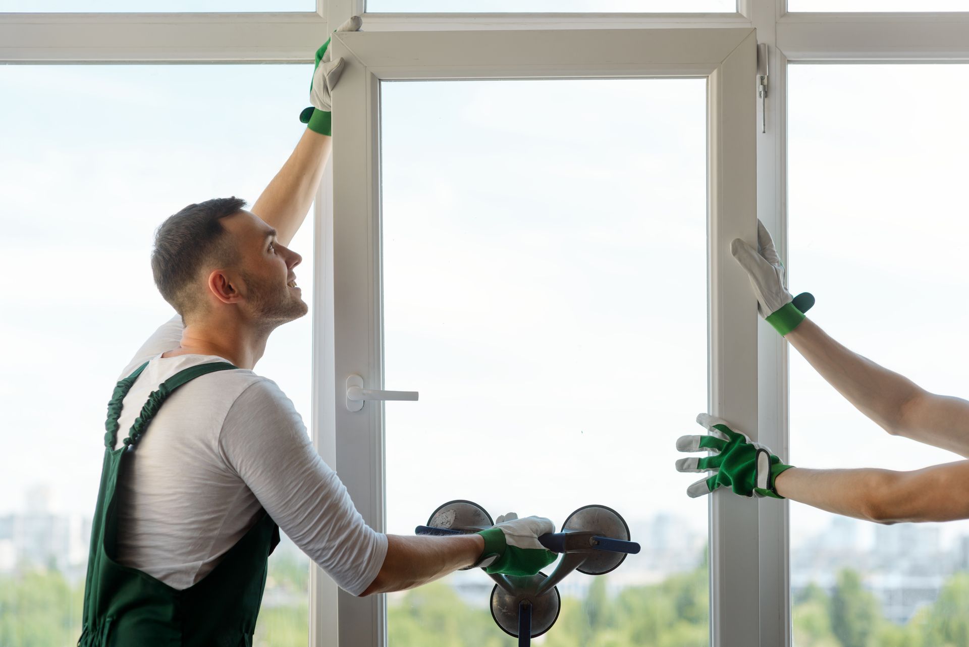 Two workers installing a window.