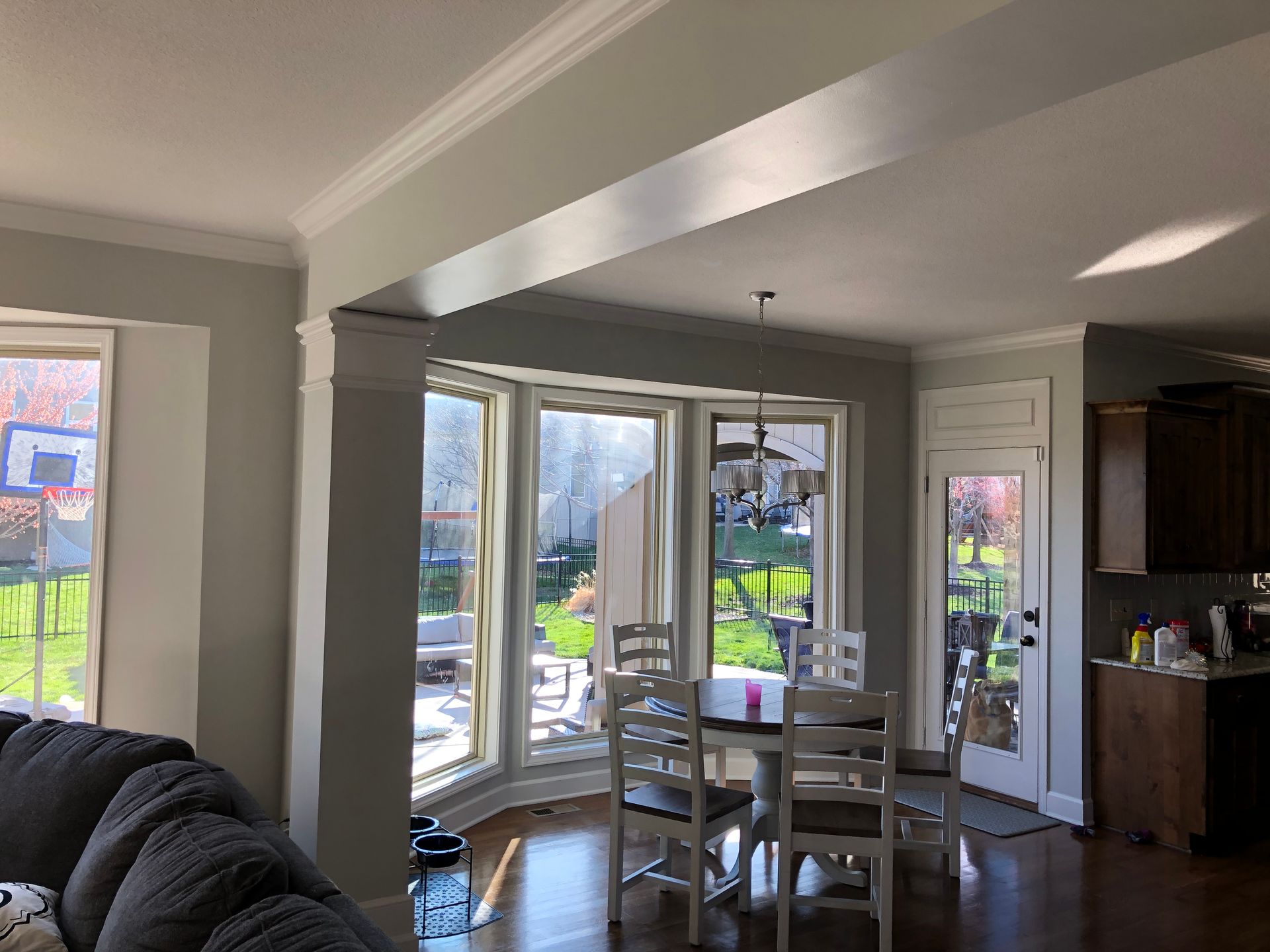 A living room and dining room in a house with a table and chairs.