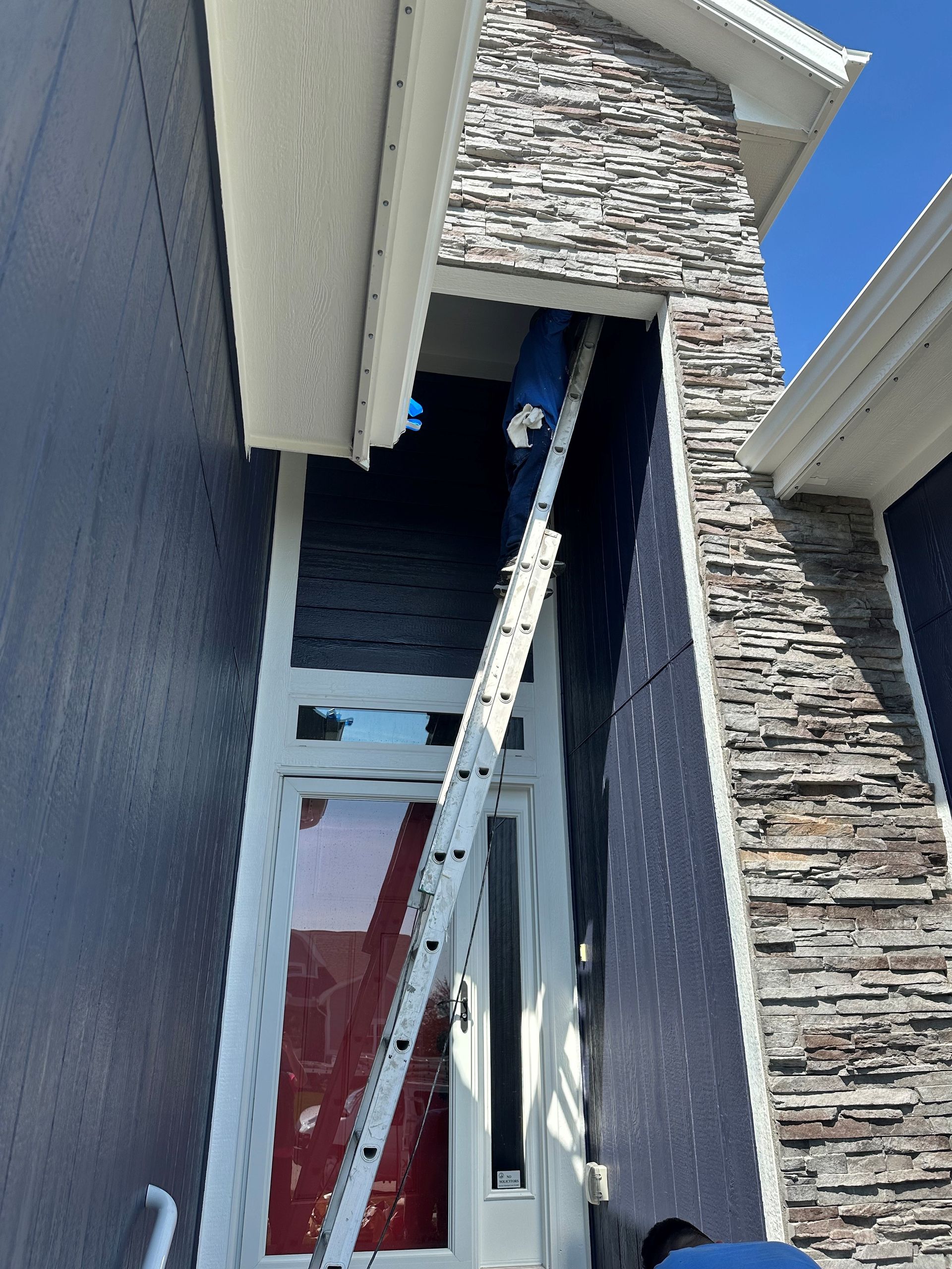 A ladder is hanging from the side of a building.