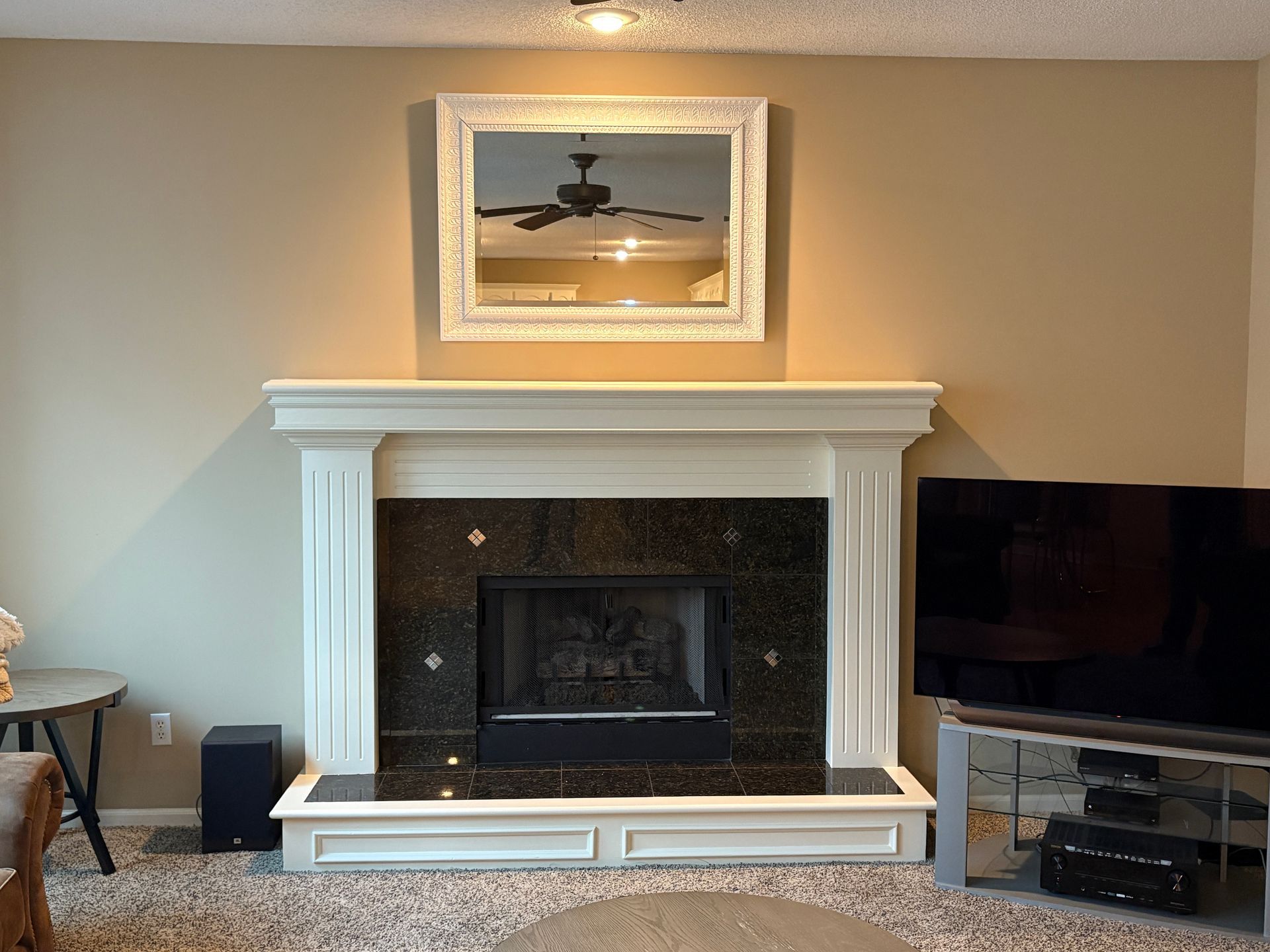A living room with a fireplace and a flat screen tv