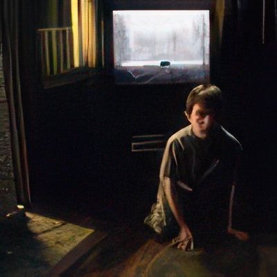 A man is kneeling down in front of a window in a dark room