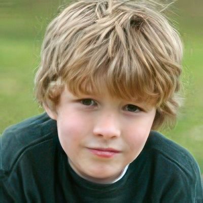 A young boy with blonde hair is wearing a green shirt