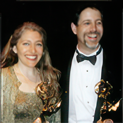 A man and a woman are holding trophies and smiling