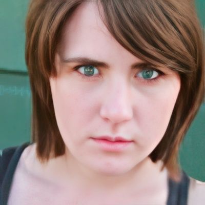 A close up of a woman 's face with green eyes