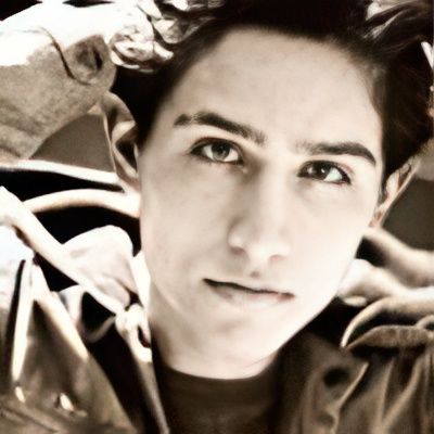 A close up of a young man 's face in a black and white photo