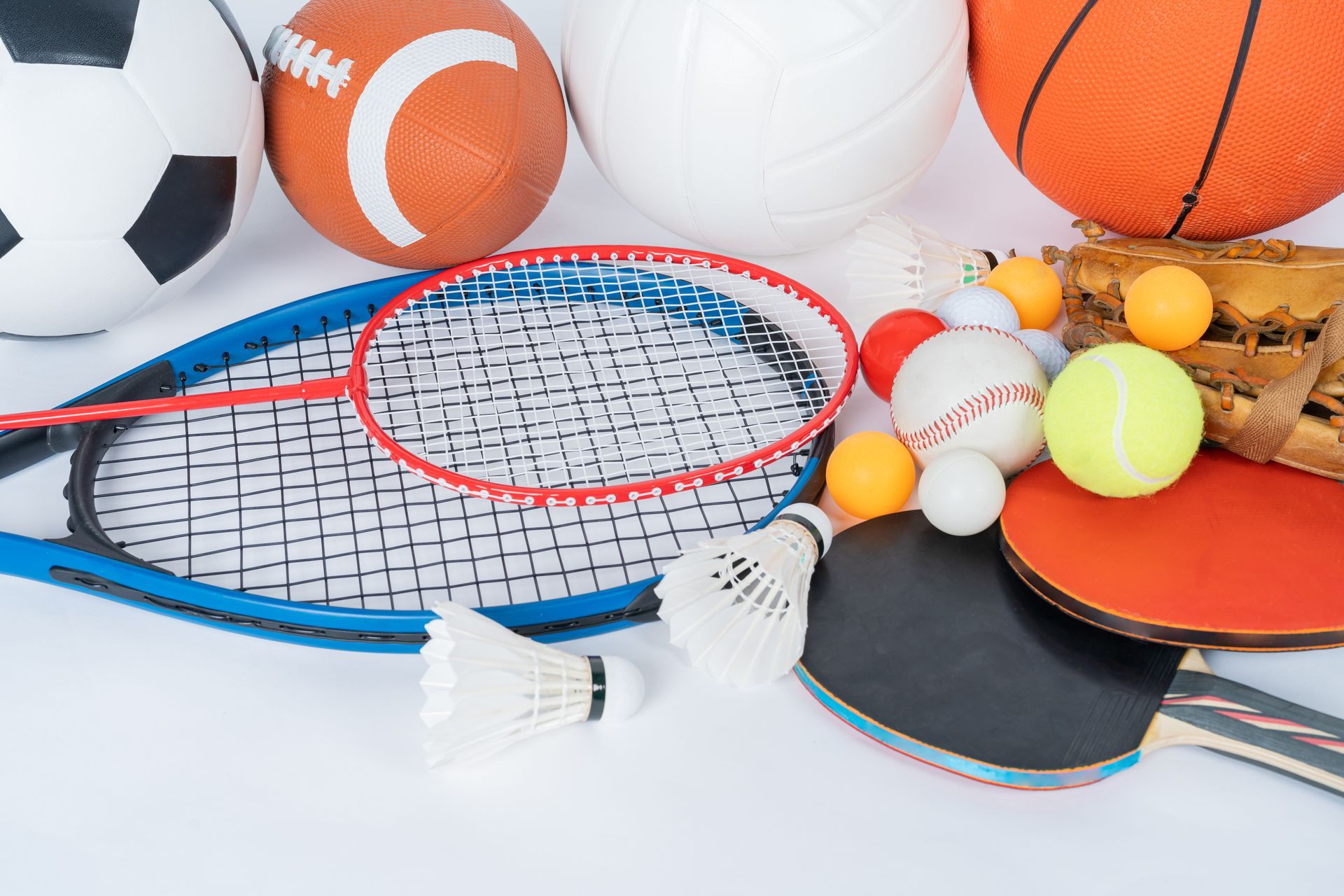 Sports balls and rackets arranged on a white background, including tennis, ping pong, soccer, and basketball.