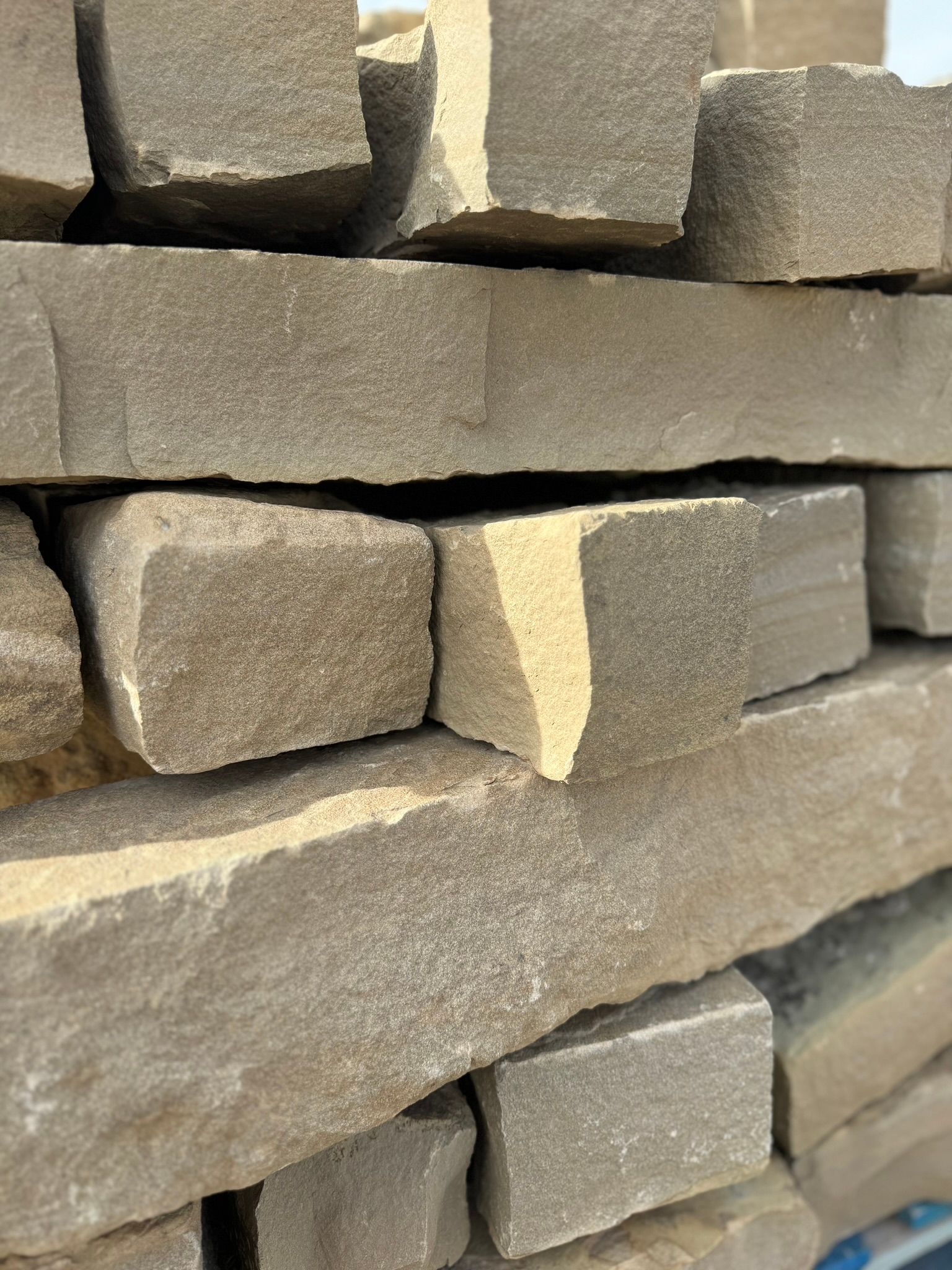 A close up of a pile of bricks stacked on top of each other.