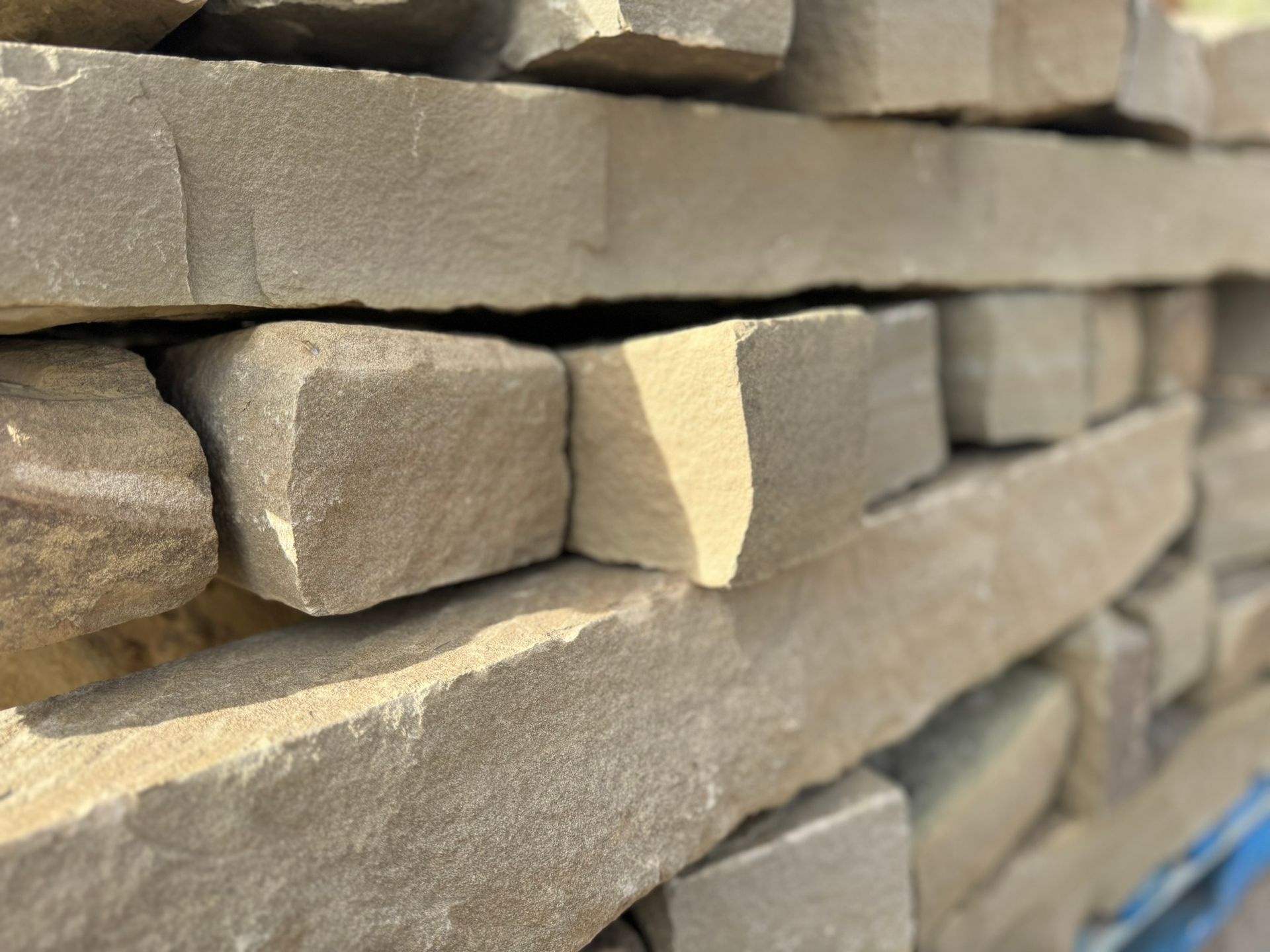 A close up of a pile of bricks stacked on top of each other.