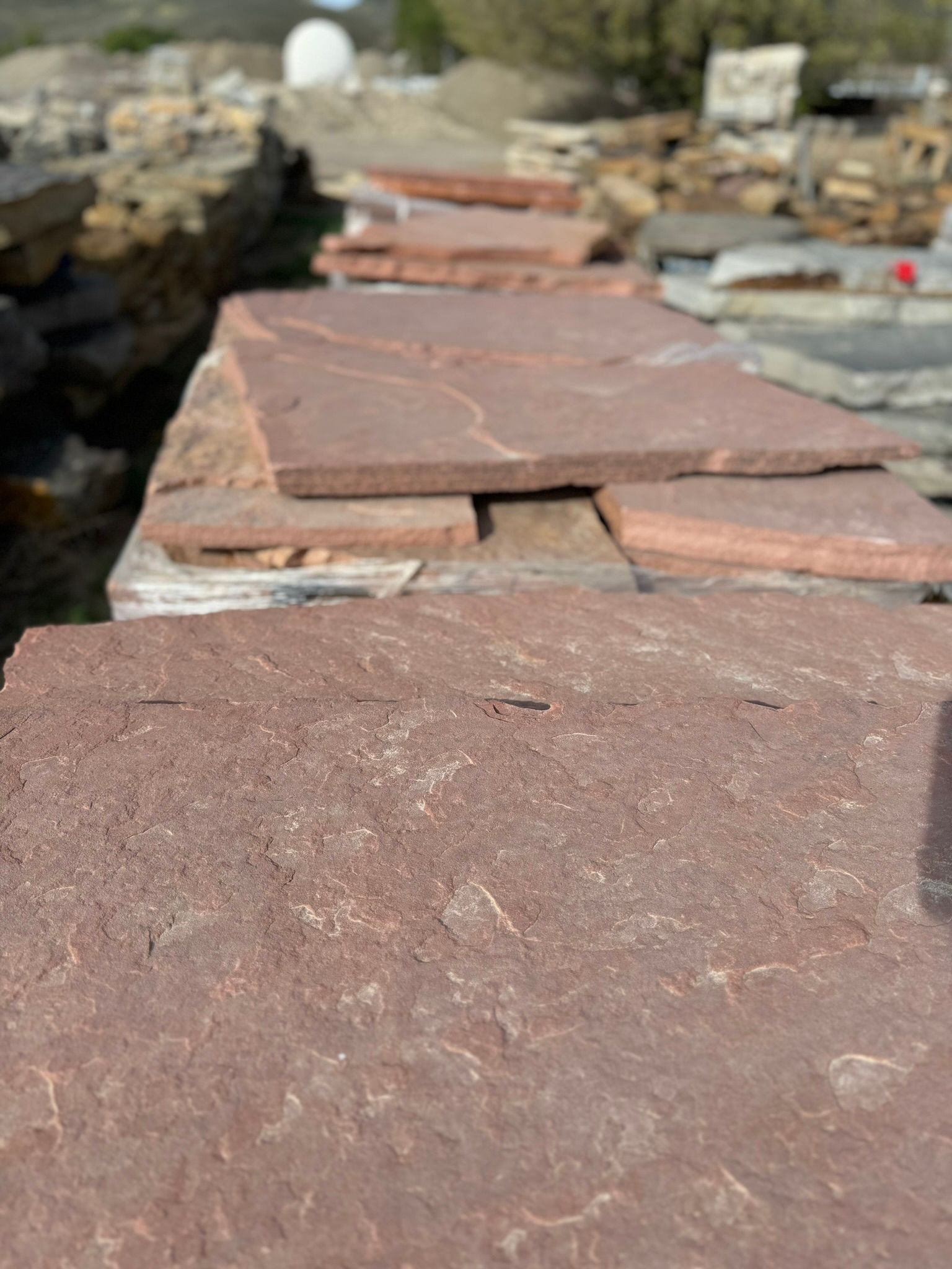 A pile of red tiles sitting on top of each other.