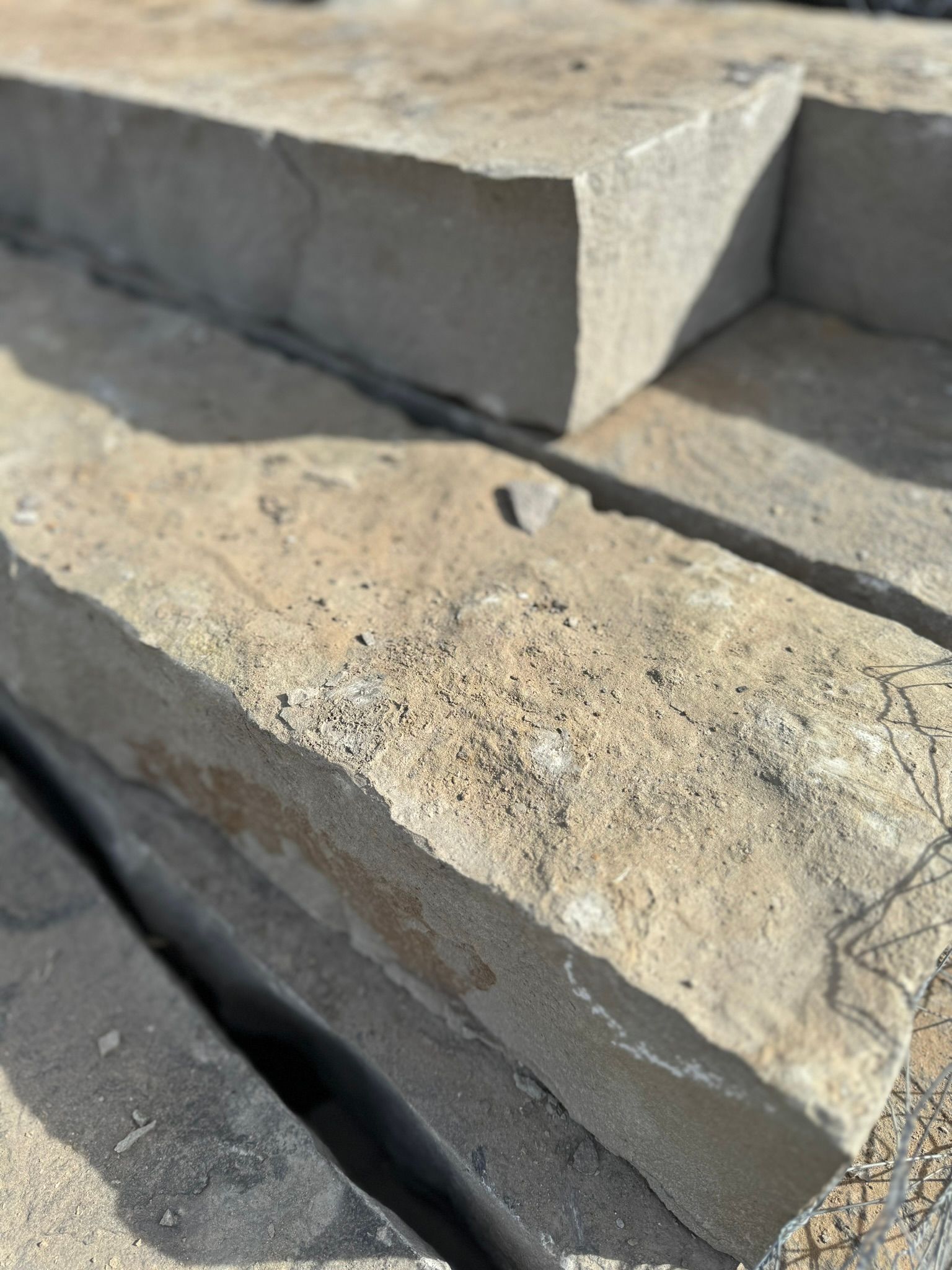 A close up of a pile of concrete blocks stacked on top of each other.