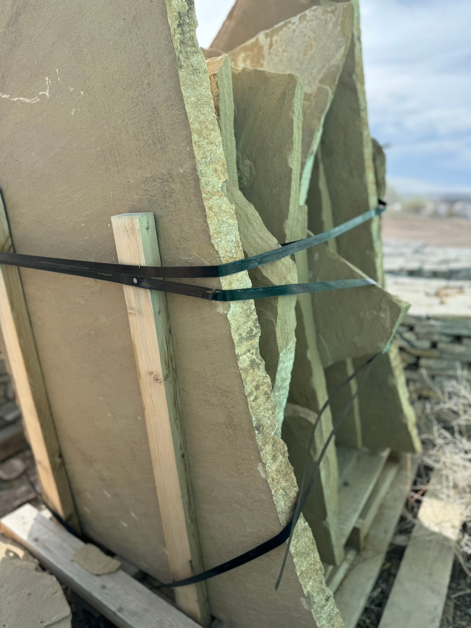 A piece of wood is tied together with a black strap.