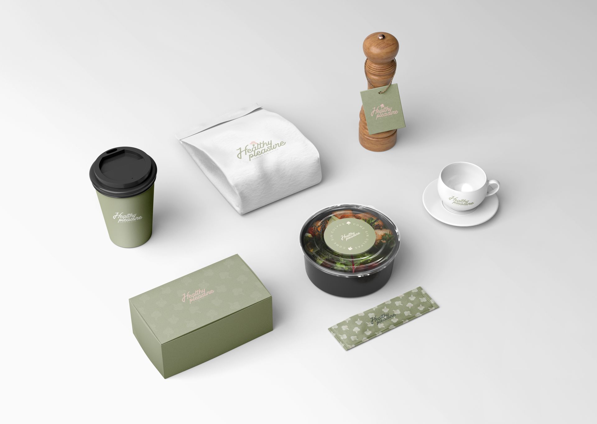 Varios artículos de café y té sobre una mesa blanca, incluyendo una taza, un vaso para llevar, una caja, un tarro y un sobre envasado.