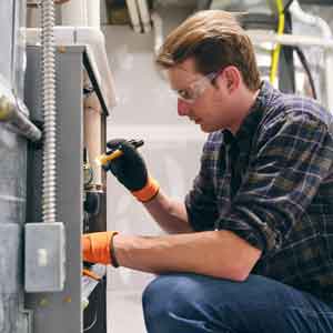 Heating Boiler — Wyoming, OH — Wyoming Air A heating contractor performing a repair in Cincinnati, OH