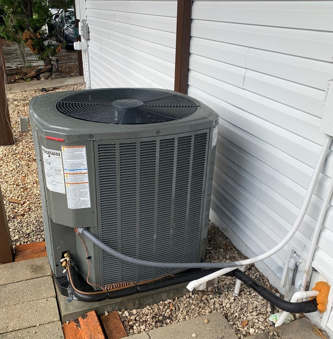 Technician inspecting HVAC air handler for repair and performance testing