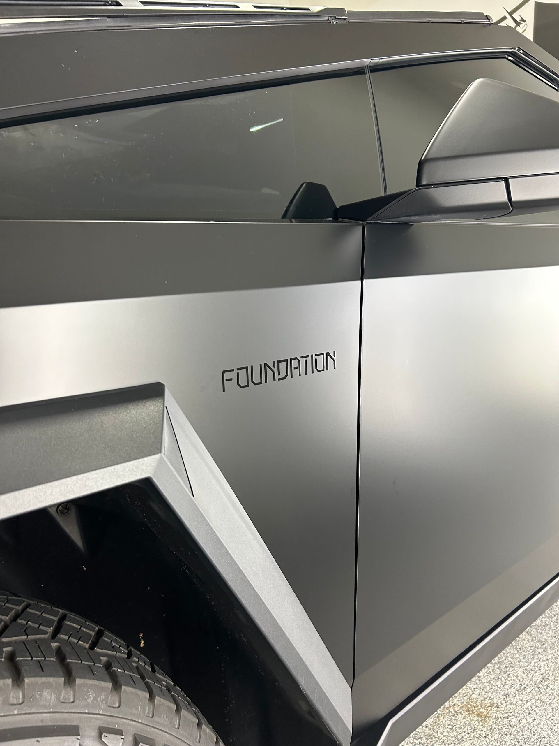 A black car with the word foundation on the side of it