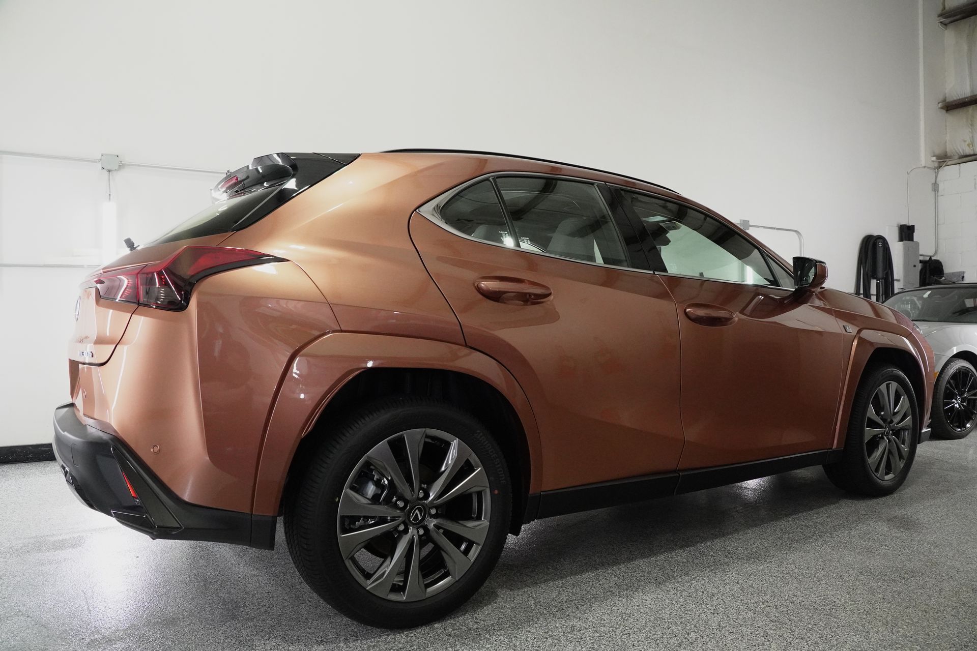 A brown car is parked in a garage.