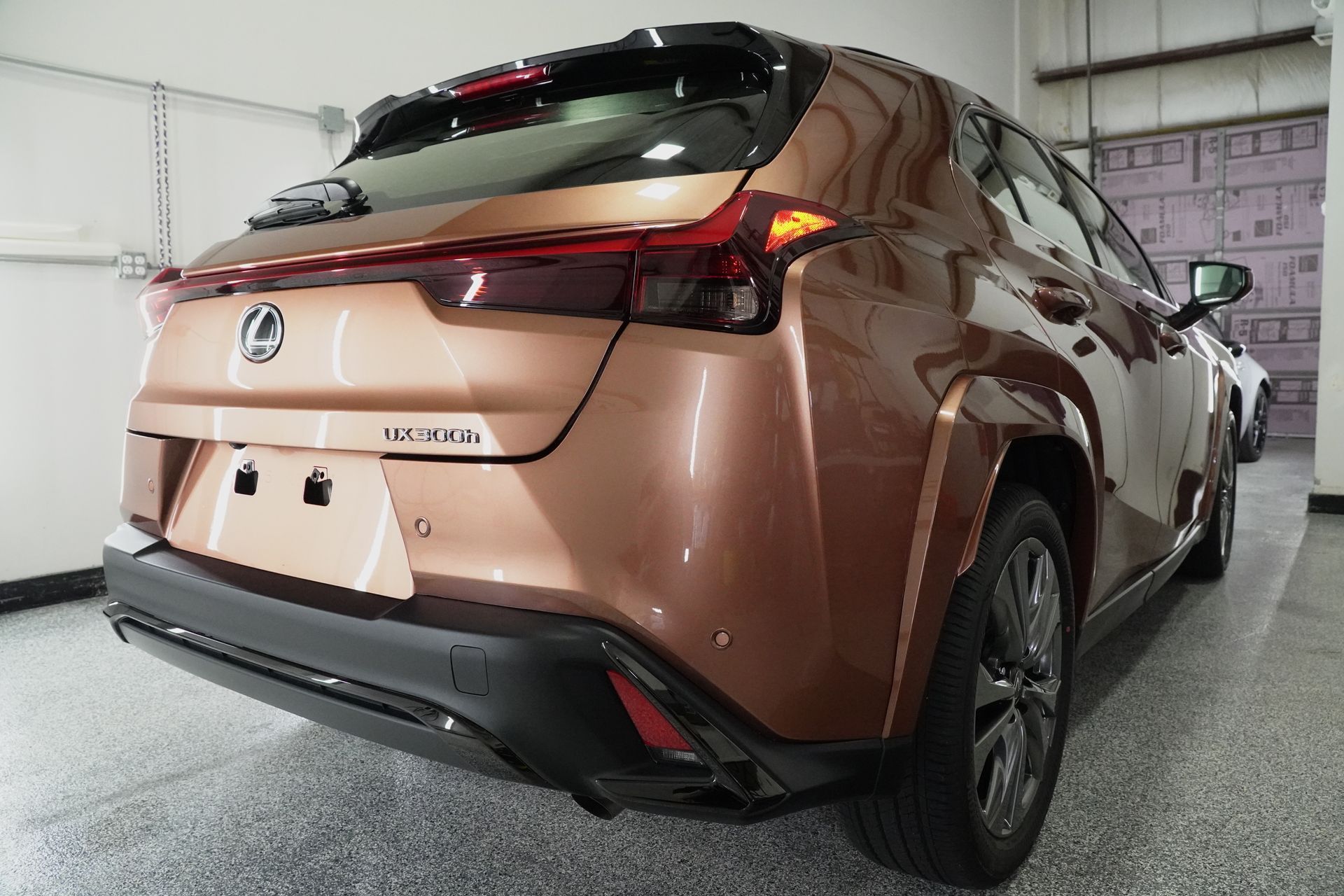 A brown car is parked in a garage.
