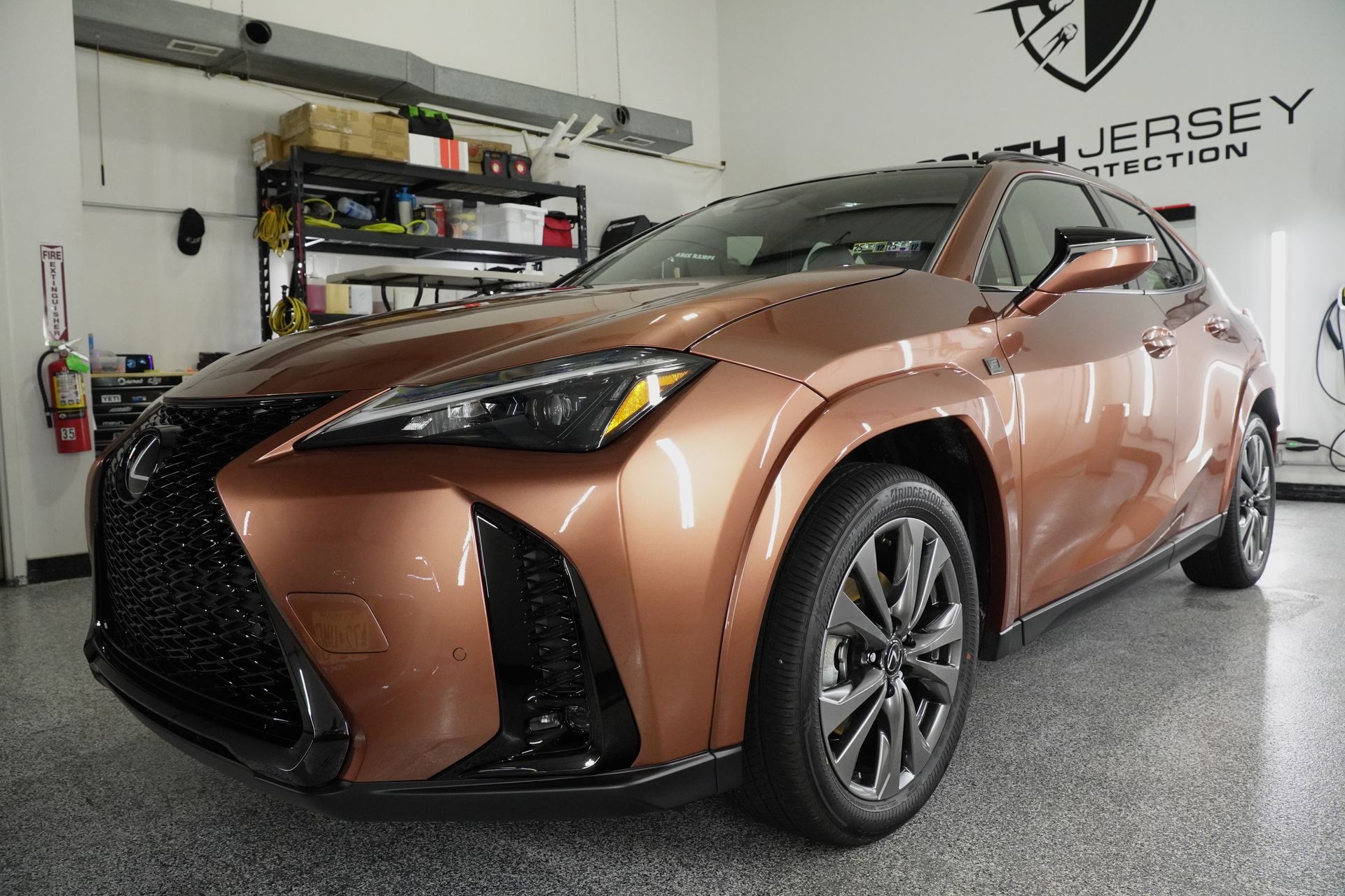 A brown lexus is parked in a garage.
