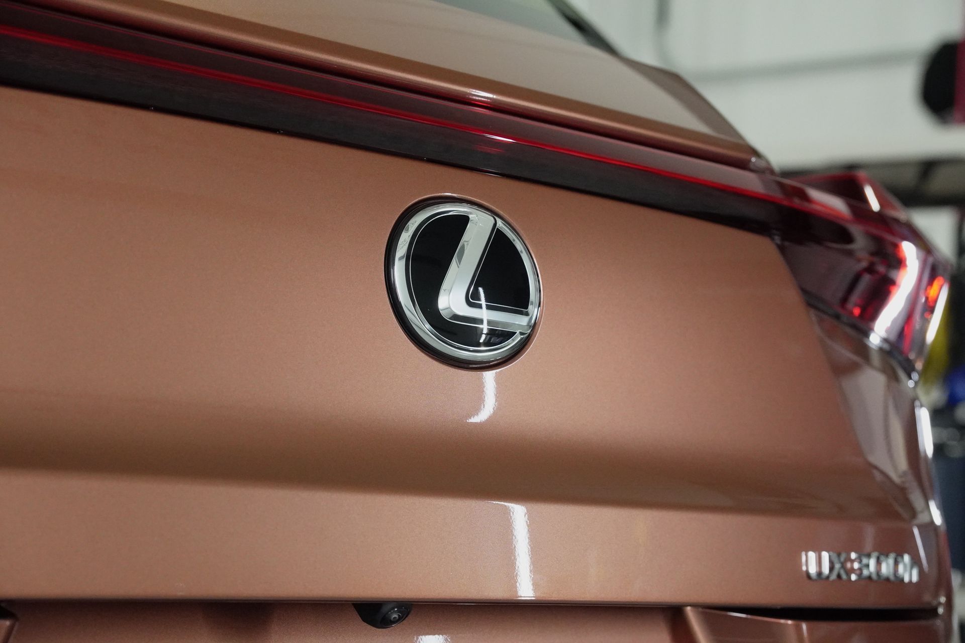 A close up of the back of a brown lexus car