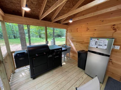 There is a grill and a refrigerator in the room.