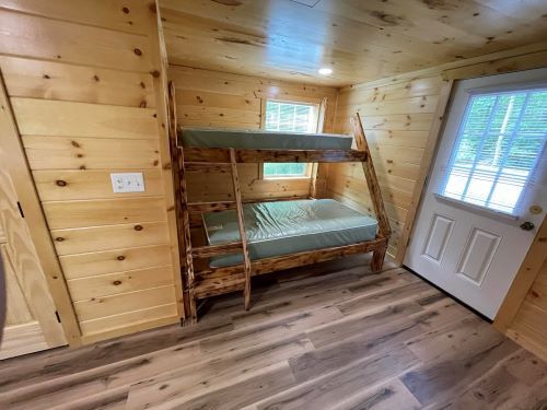 There is a bunk bed in the middle of the room.
