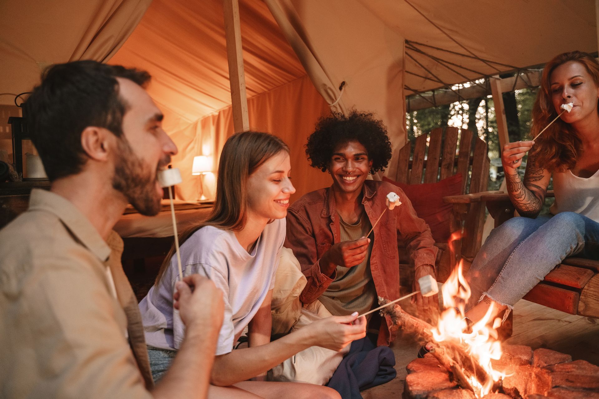 A group of people are roasting marshmallows over a campfire.