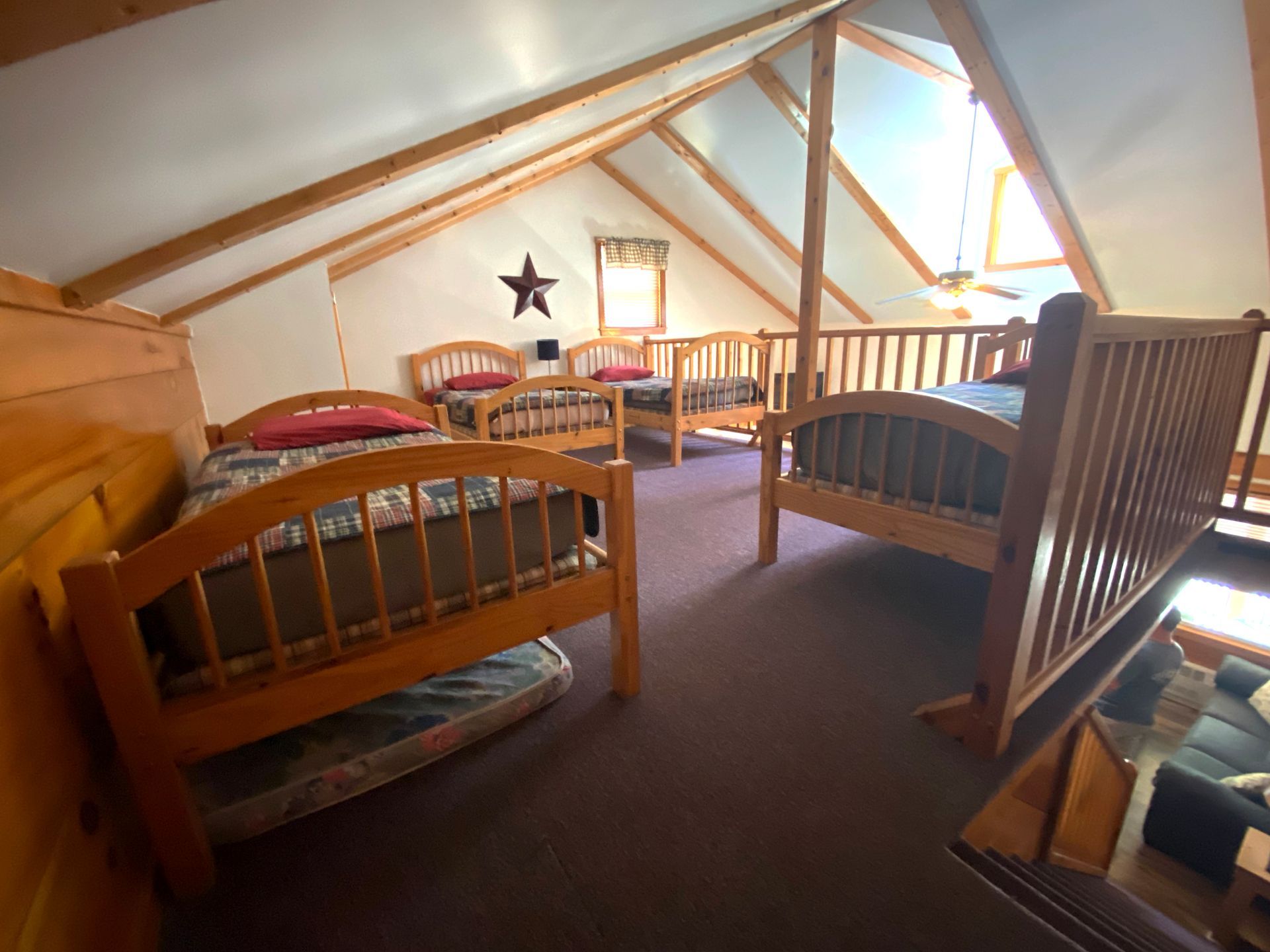 A room with four beds and a star on the wall.