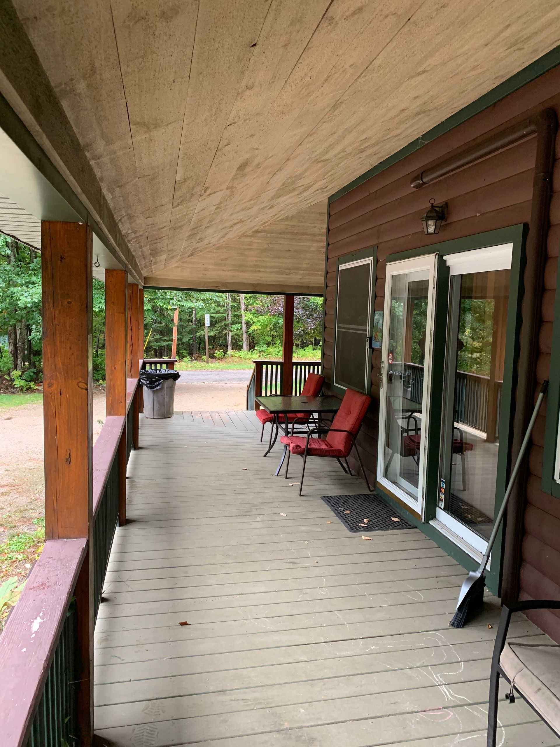 A porch with a table and chairs on it