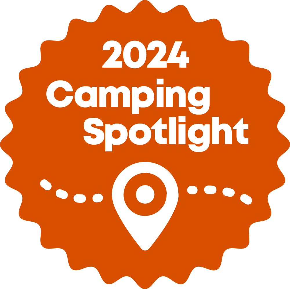 A sticker that says 2024 camping spotlight with a pin on it.