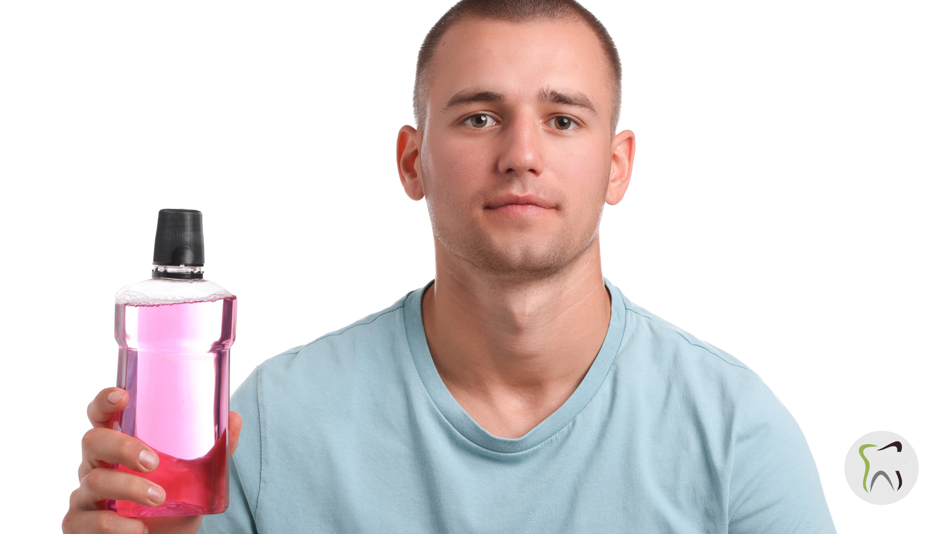 Man holding a pink mouthwash bottle, looking at the viewer against a white background.