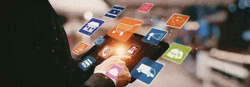 Person holding tablet with shopping app icons, symbolizing online retail and e-commerce.