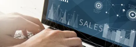 Hands typing on a laptop displaying a 