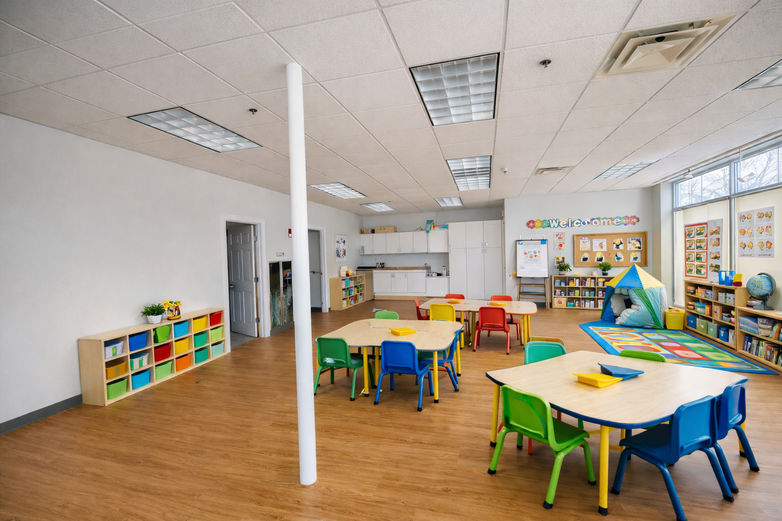 Daycare room with baby cribs, play area, and high chairs.