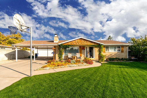 A house with a basketball hoop in front of it.