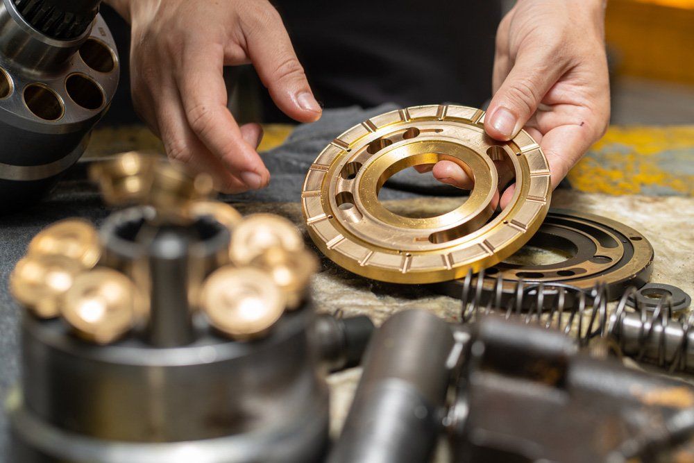 Mechanic Holding Valve Plate — Ballina Bearing Supplies In Ballina, NSW