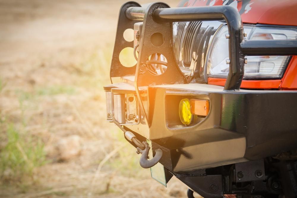 A Close Up of a Bumper on a Red Truck in a Field — Ballina Bearing Supplies In Lismore, NSW