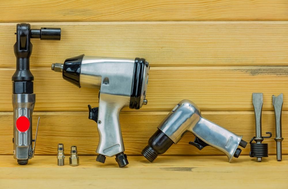 A Group of Air Tools Sitting on Top of a Wooden Table — Ballina Bearing Supplies In Grafton, NSW