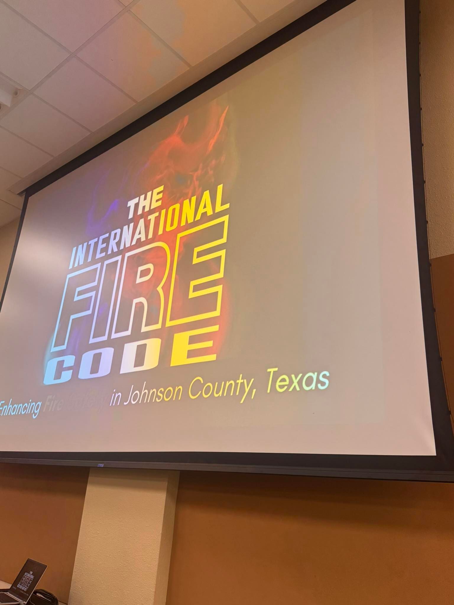 Projected slide for “The International Fire Code” with Fort Bend County, Texas text on a screen.