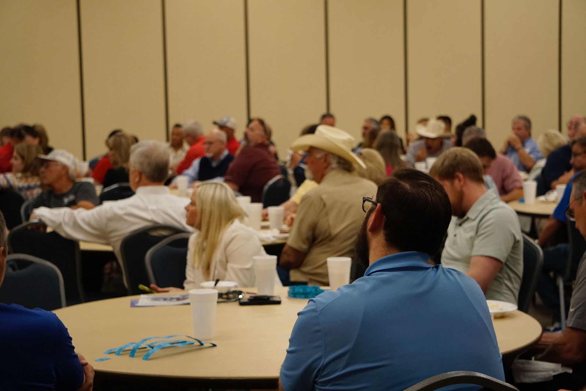 A group of people are sitting at tables in a room.
