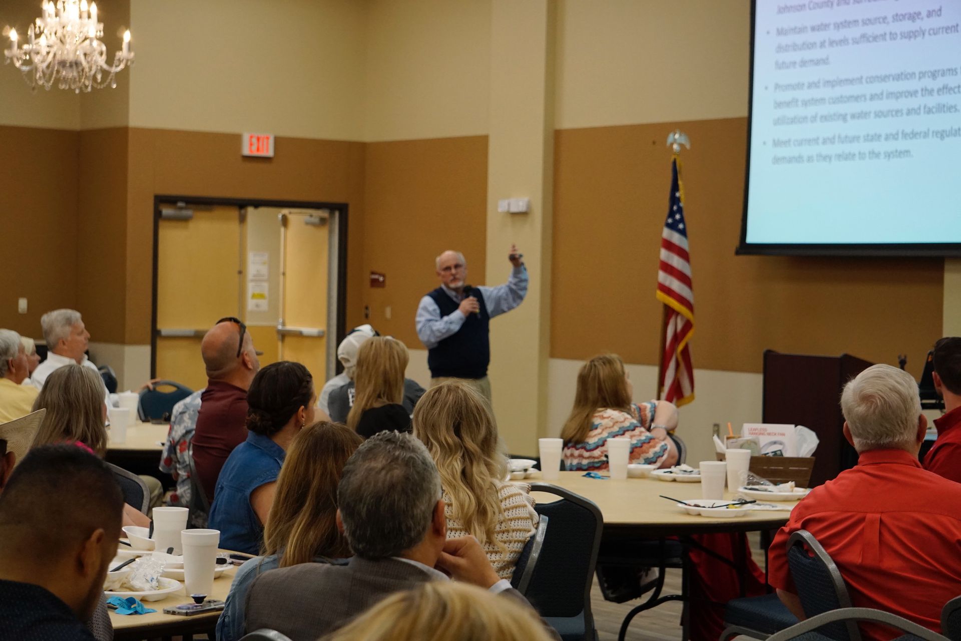 A man is giving a presentation to a group of people in a room.