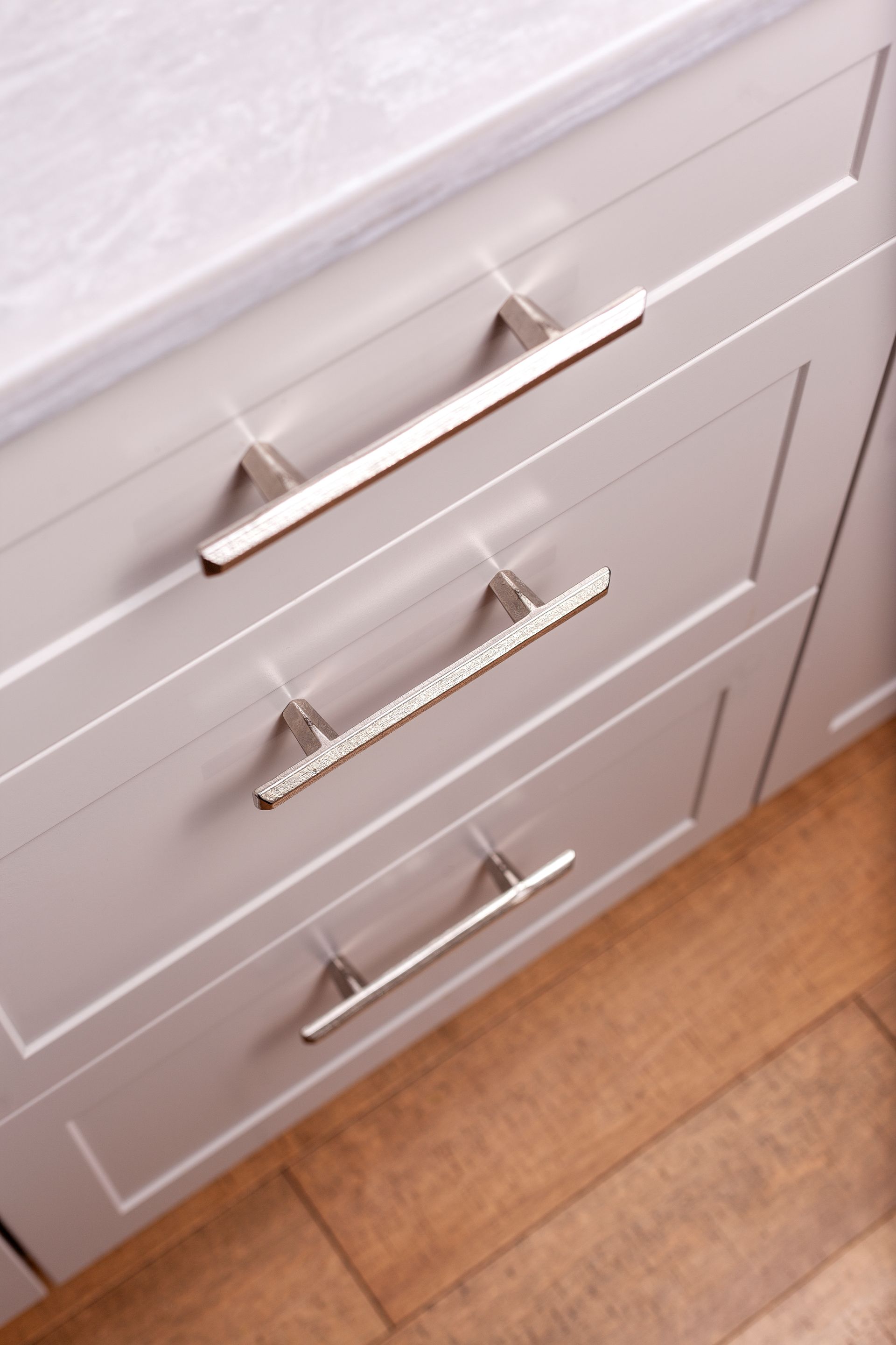 a close up of a kitchen drawer with a metal handle